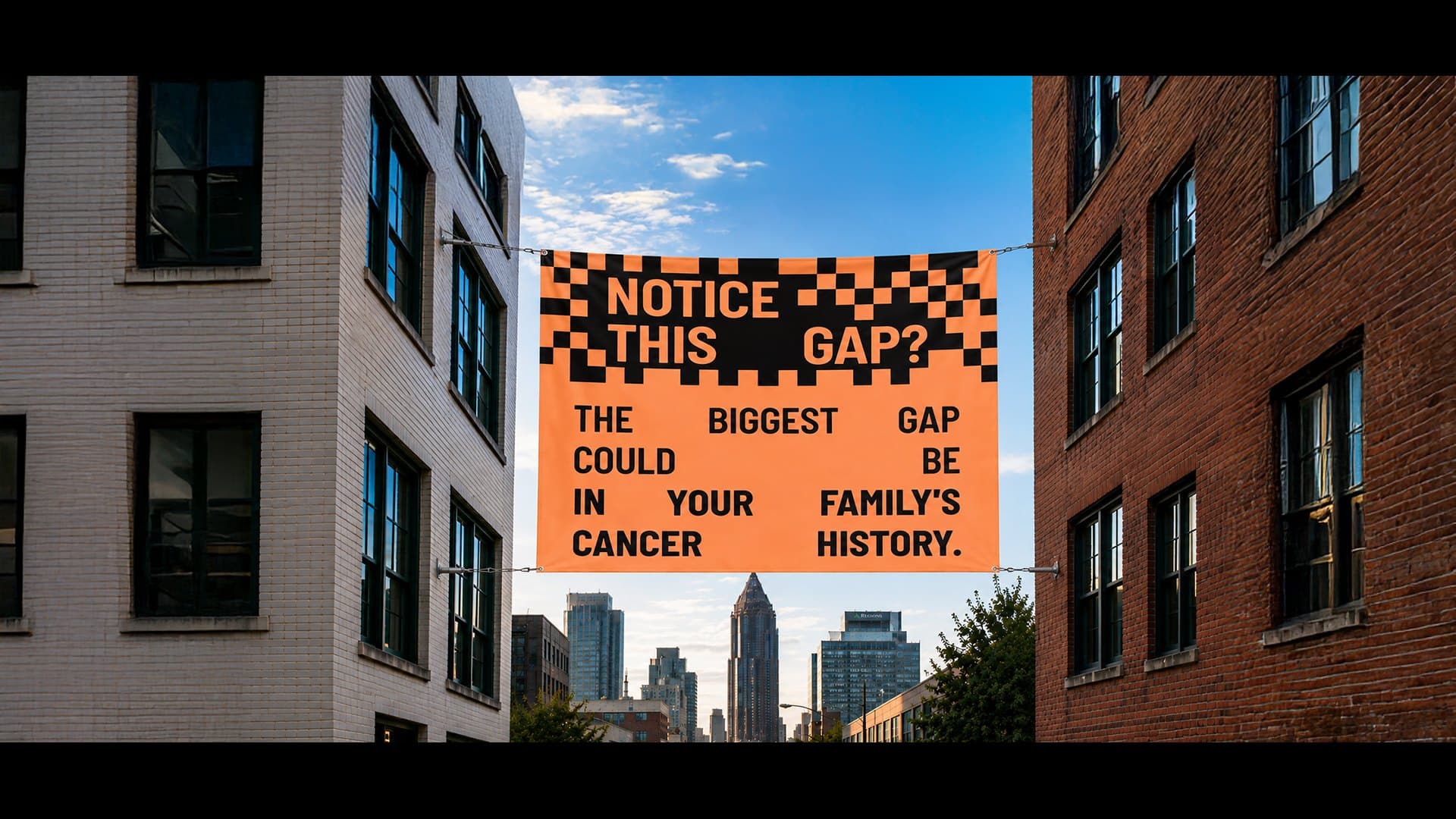 A campaign banner strung high between two brick buildings above a city street reads: Notice this gap? The biggest gap could be in your family's cancer history.